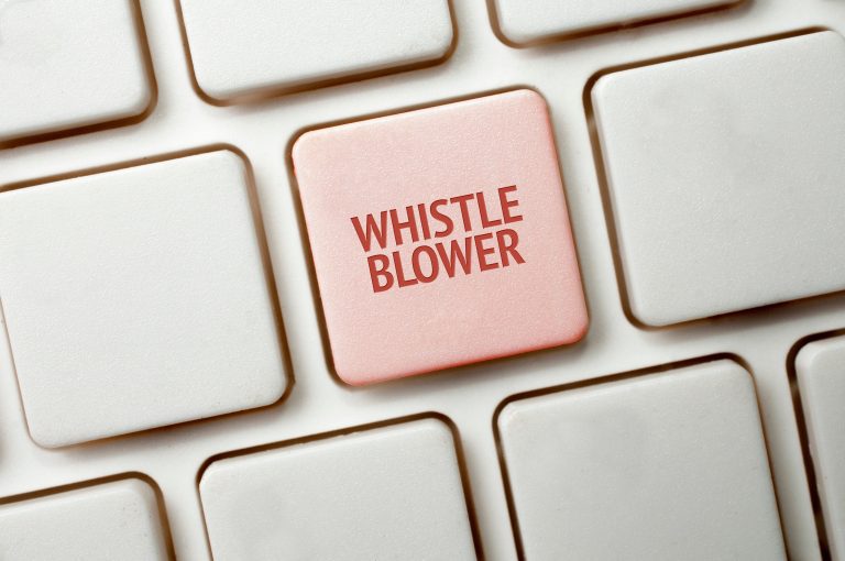 A white keyboard with a red key and the whistleblower word
