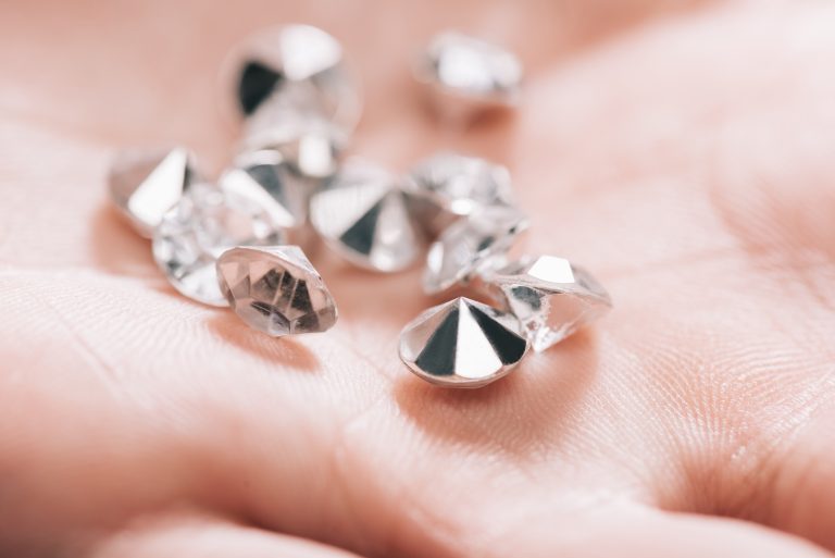 close-up-of-shiny-small-pure-diamonds-in-hand-2023-11-27-05-00-59-utc