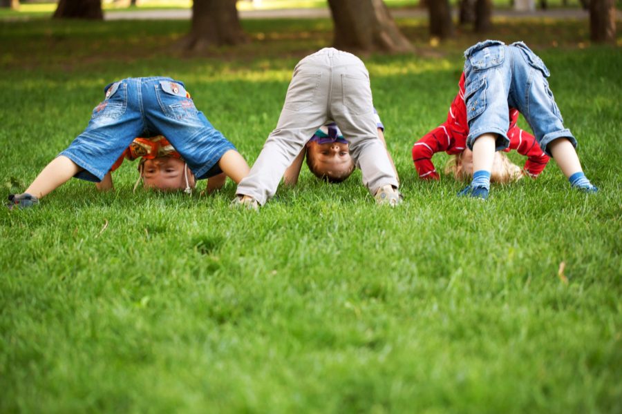 Three little boys turning somersaults